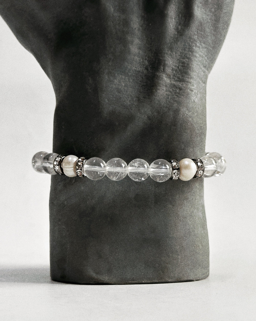 The CIRRUS®️ Quartz &amp; Pearl Bracelet features natural freshwater pearls and clear quartz strung with rhinestone-encrusted spacers in a gunmetal finish.