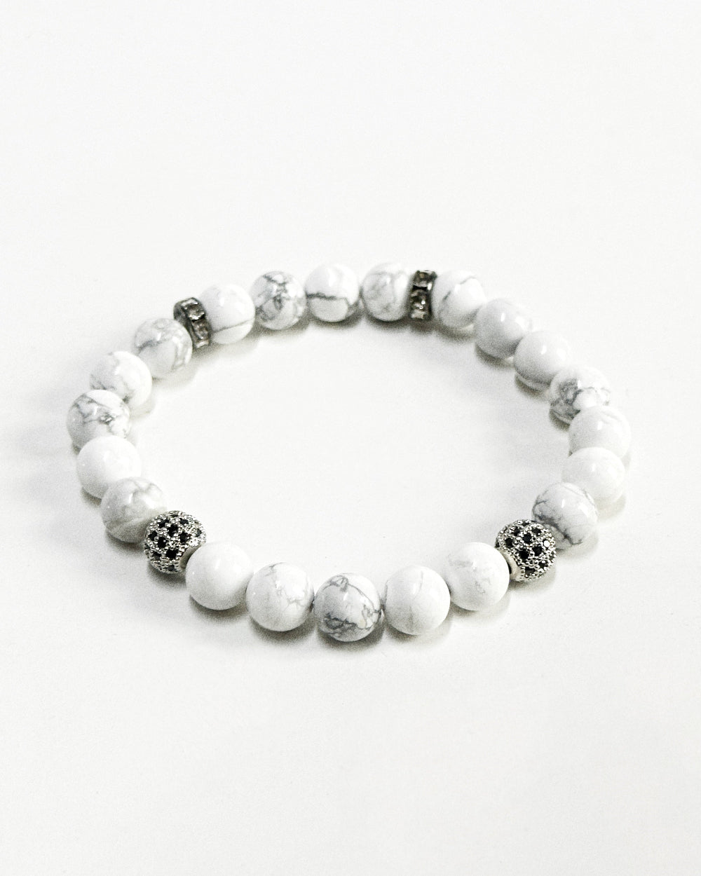 The CALLUM®️ Howlite Bracelet features natural semi-precious Howlite stones strung with Cubic Zirconia spacers in a silver finish. Strung in sturdy elastic for easy daily wear.