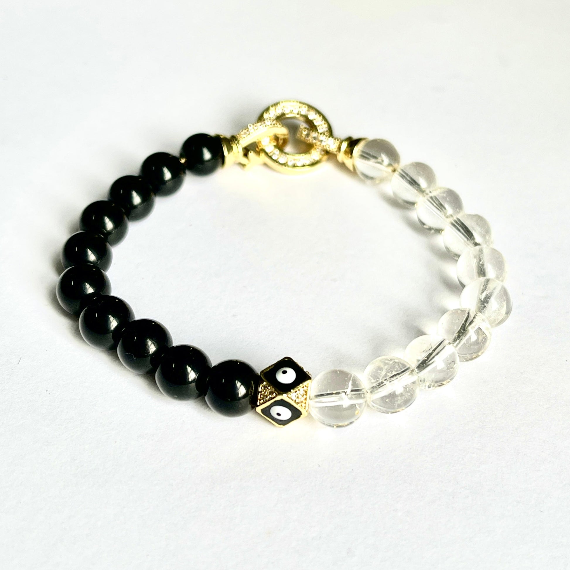 Handmade bead bracelet by Cold Gold Philippines. Features an Evil Eye Iced Out Gold spacer bead and genuine Black Onyx and Clear Quartz. It comes with the CG Infinity Lock for a secure fit.